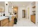 Bright bathroom features double vanities, framed mirrors, marble floors, and a walk-in closet at 10726 Hawes End Ct, Las Vegas, NV 89183