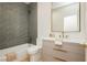 Modern bathroom with gray tiled shower and marble countertop vanity at 10726 Hawes End Ct, Las Vegas, NV 89183