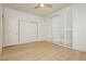 Bright bedroom with a ceiling fan, wood floors, and closet with sliding shutter doors at 10726 Hawes End Ct, Las Vegas, NV 89183