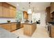 Spacious kitchen featuring custom wood cabinetry, a large island, and stainless steel appliances at 10726 Hawes End Ct, Las Vegas, NV 89183