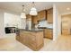 Bright kitchen featuring an island with custom cabinets, modern lighting, and stainless steel appliances at 10726 Hawes End Ct, Las Vegas, NV 89183