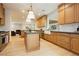 A spacious kitchen featuring custom wood cabinetry, a large island, and stainless steel appliances at 10726 Hawes End Ct, Las Vegas, NV 89183