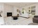 Bright living room featuring stylish decor, a decorative fireplace and backyard access for seamless indoor/outdoor living at 10726 Hawes End Ct, Las Vegas, NV 89183
