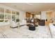 Spacious living room with abundant seating, a stylish rug, and access to the outdoor patio and kitchen at 10726 Hawes End Ct, Las Vegas, NV 89183