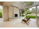Covered outdoor space with fireplace, seating, and backyard views at 10726 Hawes End Ct, Las Vegas, NV 89183
