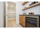 Butler's pantry features custom cabinets, countertops, open shelving, and a wine fridge at 10726 Hawes End Ct, Las Vegas, NV 89183
