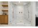 Bright walk-in shower features marble tile, dual shower heads, and built-in shelving at 10726 Hawes End Ct, Las Vegas, NV 89183