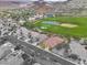 Stunning aerial view of the home with golf course and mountain backdrop at 1111 Casa Palermo Cir, Henderson, NV 89011