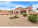 Desert landscaped backyard with mature shrubs and covered patio at 1111 Casa Palermo Cir, Henderson, NV 89011