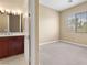 Bright bedroom with neutral carpet, cream walls and a window at 1111 Casa Palermo Cir, Henderson, NV 89011