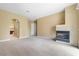 Spacious living room with a fireplace and access to other rooms at 1111 Casa Palermo Cir, Henderson, NV 89011
