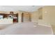Open-concept living room connecting to the kitchen with recessed lighting and neutral carpet flooring at 1111 Casa Palermo Cir, Henderson, NV 89011
