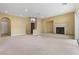 Bright living room featuring a fireplace, recessed lighting, and smooth carpet flooring at 1111 Casa Palermo Cir, Henderson, NV 89011