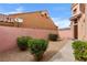 A cozy side yard space featuring gravel, shrubbery, and a walled perimeter for added privacy at 1111 Casa Palermo Cir, Henderson, NV 89011