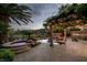 Wide shot of a luxurious backyard with a stunning pool, spa, waterfall, covered patio, and outdoor kitchen, perfect for entertaining at 11359 Winter Cottage Pl, Las Vegas, NV 89135