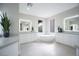 Bright primary bathroom featuring dual vanities, a soaking tub, and modern fixtures at 11359 Winter Cottage Pl, Las Vegas, NV 89135
