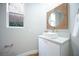 Modern powder room with a vessel sink, stylish mirror, and neutral color scheme, offering a sleek and functional space at 11359 Winter Cottage Pl, Las Vegas, NV 89135