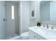 Modern bathroom featuring a walk-in shower, white vanity, and sleek fixtures at 11359 Winter Cottage Pl, Las Vegas, NV 89135
