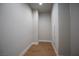 A narrow, walk-in closet with wood floors and white trim at 11359 Winter Cottage Pl, Las Vegas, NV 89135