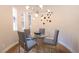 Stylish dining area with modern chandelier, table, and ample natural light at 11359 Winter Cottage Pl, Las Vegas, NV 89135