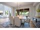 Elegant dining room with modern lighting, stylish decor, and expansive backyard views at 11359 Winter Cottage Pl, Las Vegas, NV 89135
