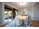 Stylish dining room featuring a large glass sliding door leading to the patio, perfect for indoor/outdoor dining at 11359 Winter Cottage Pl, Las Vegas, NV 89135