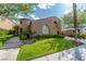 Charming two-story home with a well-manicured lawn, mature trees, and distinctive architectural details at 11359 Winter Cottage Pl, Las Vegas, NV 89135