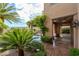Exterior perspective shows a home's outdoor pool with waterfall feature and lush landscaping, enhancing its curb appeal at 11359 Winter Cottage Pl, Las Vegas, NV 89135