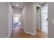 Hallway with wood flooring and neutral walls leading to bedroom and bathroom at 11359 Winter Cottage Pl, Las Vegas, NV 89135