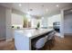 Bright kitchen featuring a large island with seating and modern stainless steel appliances at 11359 Winter Cottage Pl, Las Vegas, NV 89135