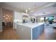 Open-concept kitchen with a large island, pendant lighting, and seamless transition to living area at 11359 Winter Cottage Pl, Las Vegas, NV 89135
