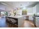 Bright, open kitchen with an island, stainless appliances, and access to the living room with a view at 11359 Winter Cottage Pl, Las Vegas, NV 89135
