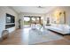Spacious living room with a fireplace, access to a patio, and modern decor at 11359 Winter Cottage Pl, Las Vegas, NV 89135