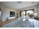 Bright living room with a modern fireplace, large windows, and open layout at 11359 Winter Cottage Pl, Las Vegas, NV 89135