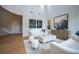 Elegant living room with high ceilings, neutral decor, and hardwood floors, perfect for relaxing or entertaining at 11359 Winter Cottage Pl, Las Vegas, NV 89135