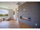 Modern living room with sleek fireplace, hardwood floors, and abundant natural light at 11359 Winter Cottage Pl, Las Vegas, NV 89135