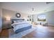 Spacious primary bedroom featuring a ceiling fan, lots of natural light, and luxury vinyl plank flooring at 11359 Winter Cottage Pl, Las Vegas, NV 89135