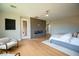 Spacious main bedroom featuring a modern fireplace, ceiling fan, and access to outdoor living at 11359 Winter Cottage Pl, Las Vegas, NV 89135