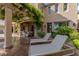 Inviting outdoor patio with lounge chairs, lush greenery, and a pergola-covered seating area for relaxing and entertaining at 11359 Winter Cottage Pl, Las Vegas, NV 89135