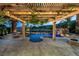 Outdoor living area showcases lagoon-style pool with a waterfall, covered patio, and an outdoor kitchen, perfect for entertaining at 11359 Winter Cottage Pl, Las Vegas, NV 89135