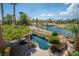 Inviting pool and lush landscaping, enhanced by a scenic lake view in the daytime, making it a serene outdoor oasis at 11359 Winter Cottage Pl, Las Vegas, NV 89135