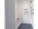 Modern shower with textured white tile, a built-in bench, and a pebble-tiled floor at 11359 Winter Cottage Pl, Las Vegas, NV 89135