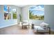 Sitting area with large windows offering exterior views and two modern chairs at 11359 Winter Cottage Pl, Las Vegas, NV 89135