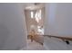 Sweeping staircase showcasing modern lighting fixture and providing views into the living spaces at 11359 Winter Cottage Pl, Las Vegas, NV 89135