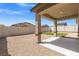 Spacious backyard with gravel, synthetic grass, and a covered patio at 13 Deseo Ct, North Las Vegas, NV 89031