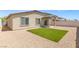 Backyard with a small patch of artificial grass and a covered patio at 13 Deseo Ct, North Las Vegas, NV 89031
