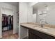 Bathroom vanity with granite countertops and a walk-in closet at 13 Deseo Ct, North Las Vegas, NV 89031