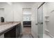 Bright bathroom featuring granite counters, wood-style floors, and a glass shower enclosure at 13 Deseo Ct, North Las Vegas, NV 89031
