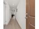 Bright hallway with light wood floors and access to multiple rooms at 13 Deseo Ct, North Las Vegas, NV 89031