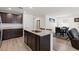 Open kitchen featuring dark wood cabinets, stainless appliances, and granite countertops at 13 Deseo Ct, North Las Vegas, NV 89031
